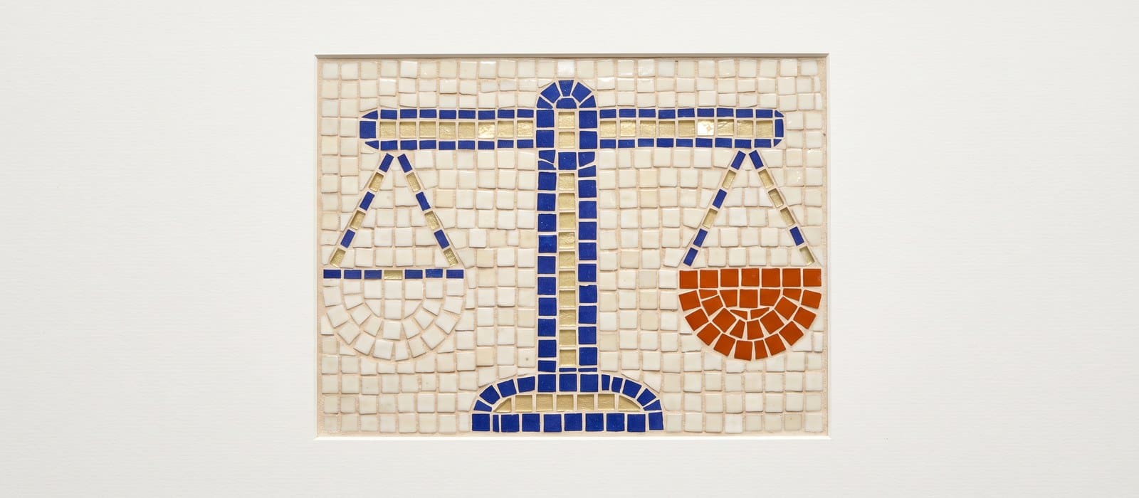 Mosaic tile artwork of a level two-pan balance scale, one pan picked out in burnt orange