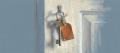Soft pastel drawing on blue-grey paper of a house key with an orange tag hanging on a hook beside a door frame