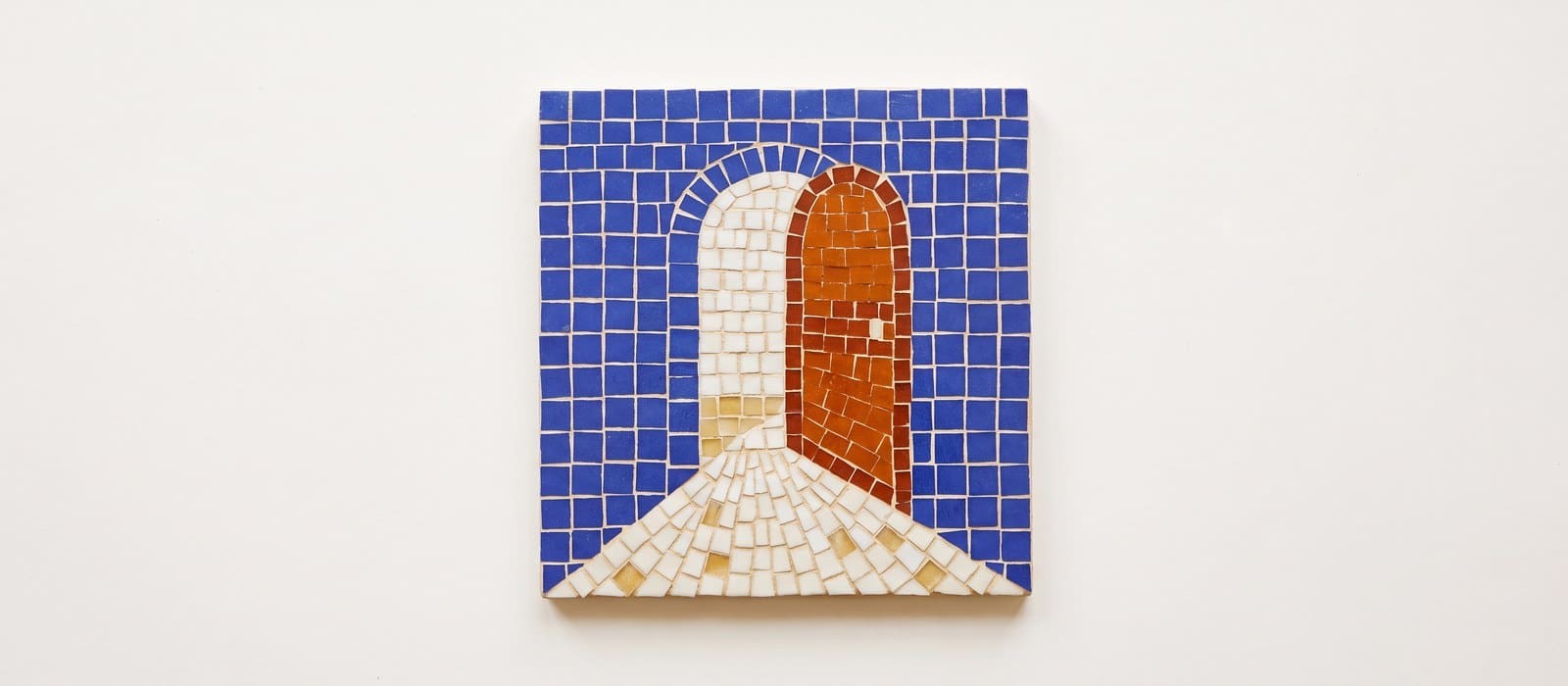 Mosaic tile artwork of an open doorway with light spilling across the floor, the door in burnt orange