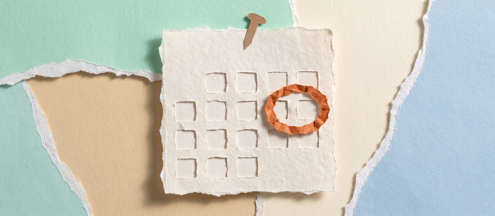Torn-paper collage of a blank wall calendar page with one day circled in burnt orange