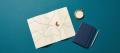 A cream road map with an orange push pin at a fork in the road, a brass compass and a navy notebook on deep teal paper, representing diversion away from prosecution