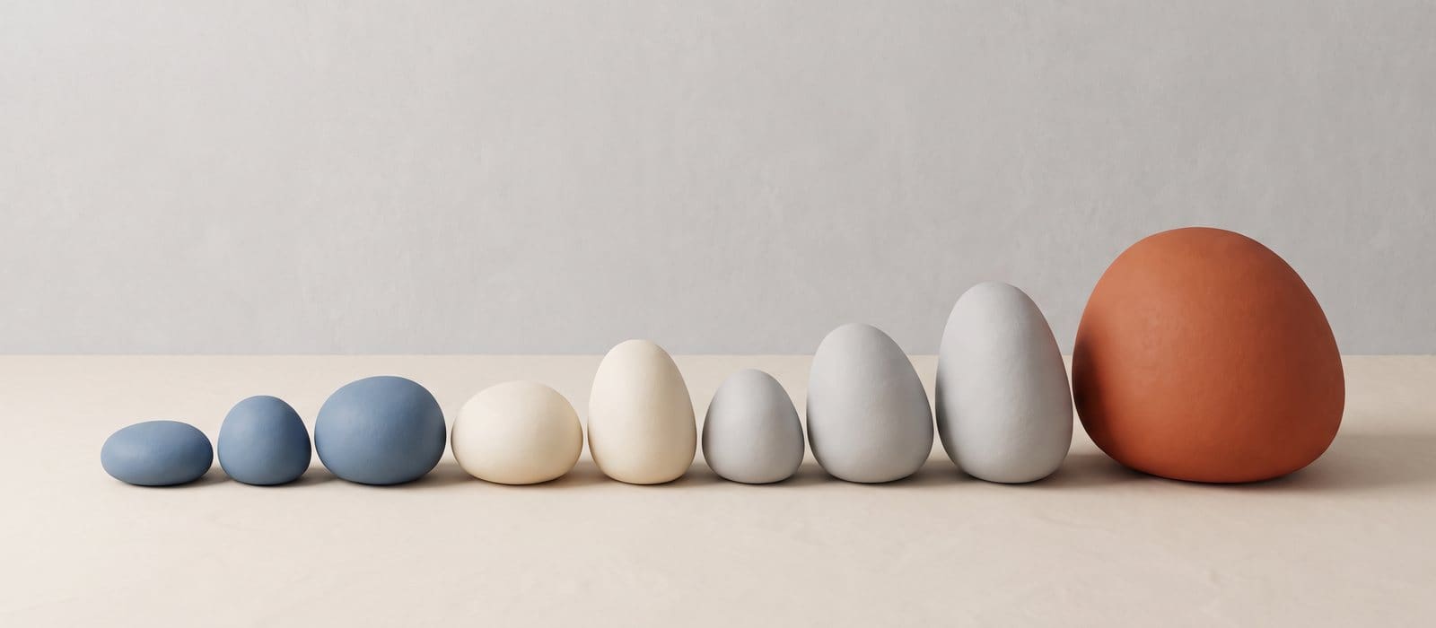 Clay-style 3D row of stones growing in size, the largest in orange