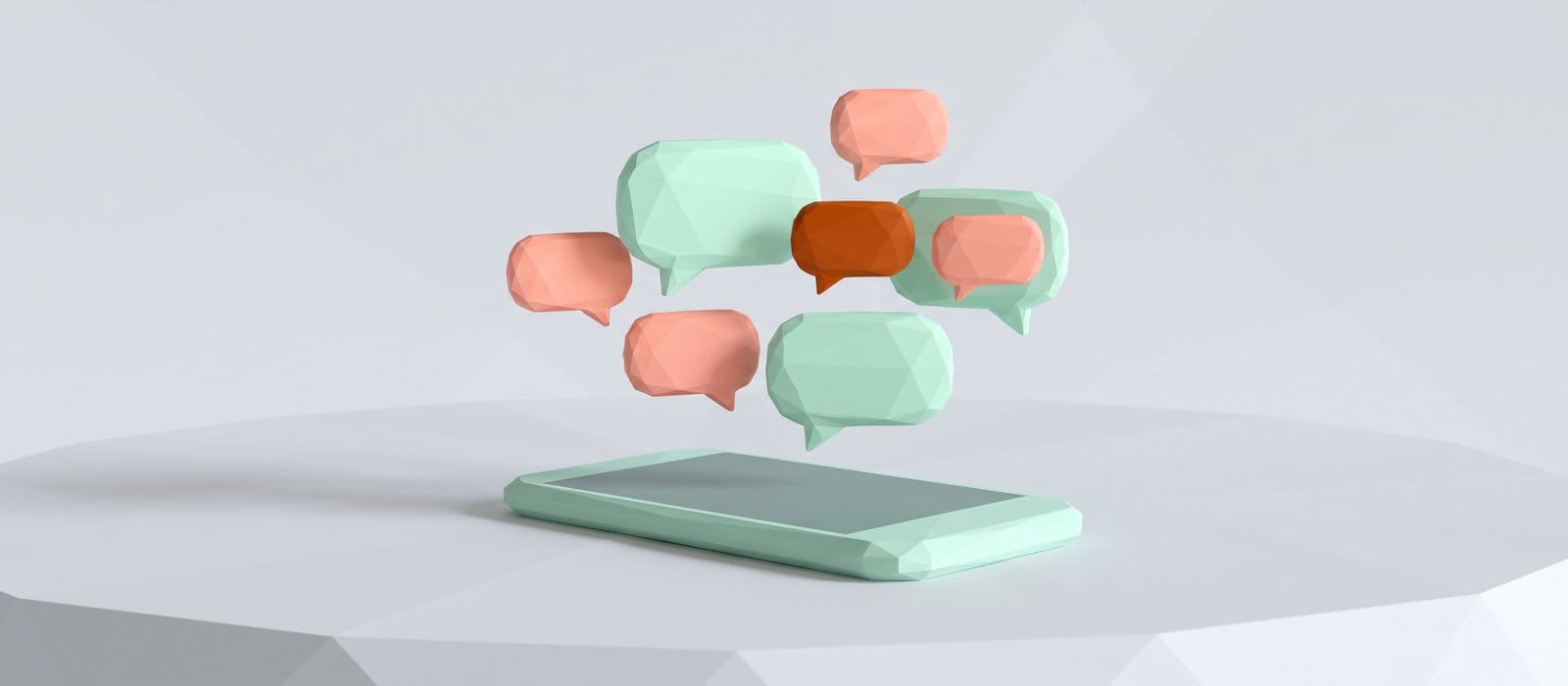 Low-poly 3D render of a smartphone lying on a table with blank mint and coral message bubbles above it, one burnt orange