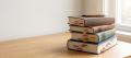 A stack of legal textbooks flagged with coloured tabs, representing expertise in sexual offence law